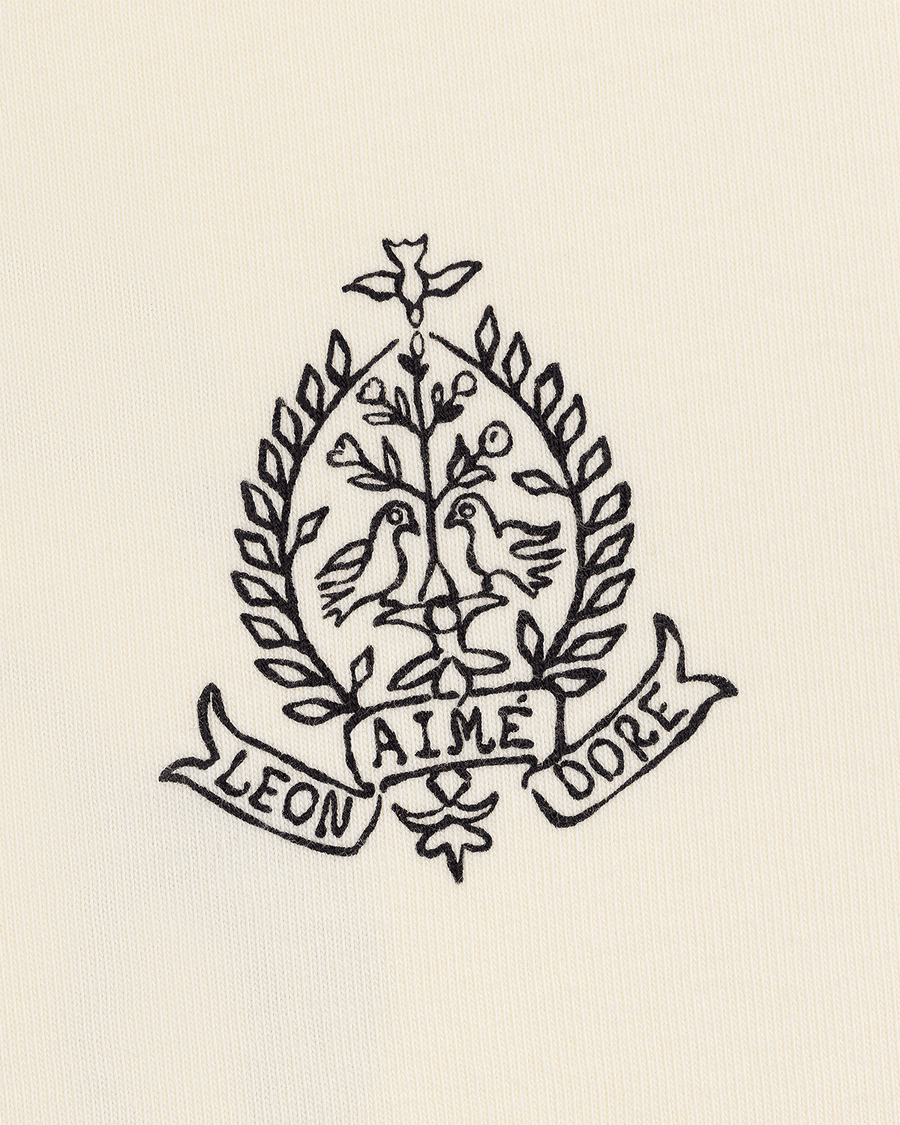 Camiseta Aimé Leon Dore Saint George Coconut Milk Bege