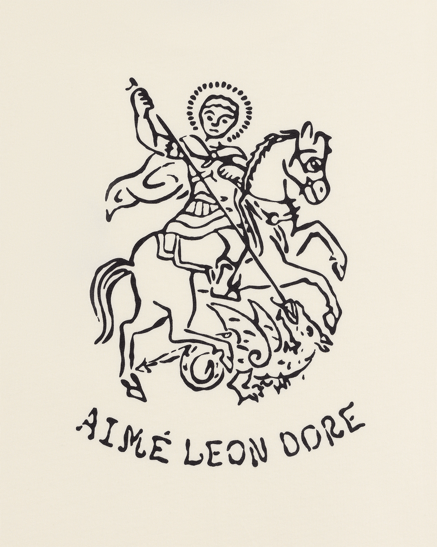 Camiseta Aimé Leon Dore Saint George Coconut Milk Bege