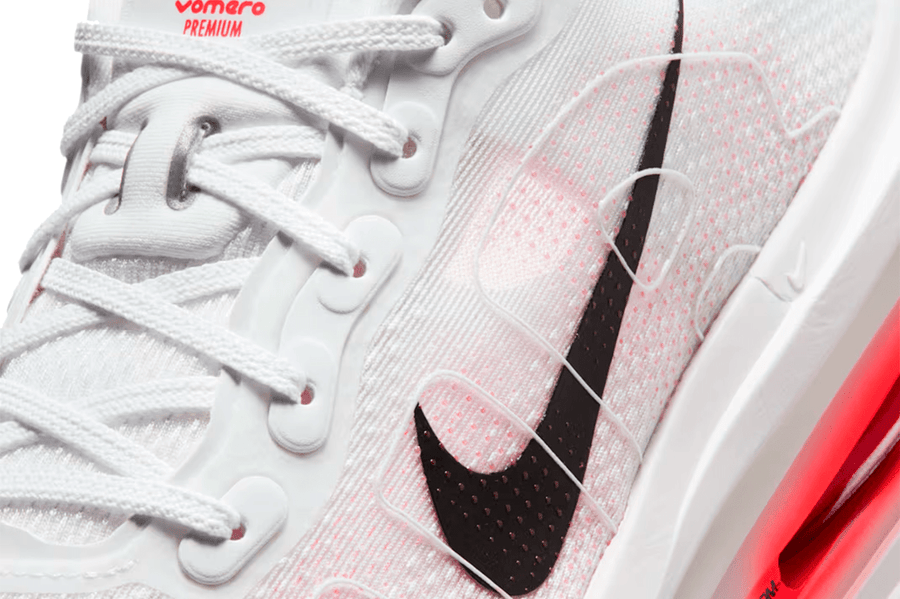 Tênis Nike Vomero Premium Branco com detalhes em Bright Crimson, close-up.